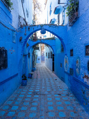 Chefchaouen,  the blue city in Morocco - arches along a narrow street in the Medina.