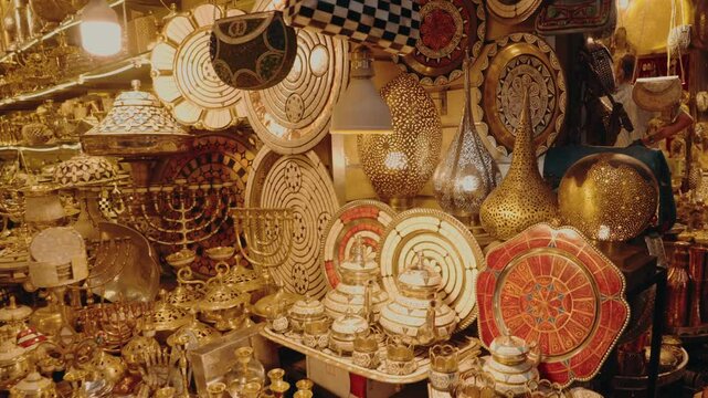 Traditional Moroccan shop displays authentic, handcrafted metal goods. Gold, silver, and copper items shine under warm lights. This vibrant marketplace showcases cultural heritage