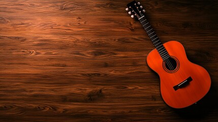 Fototapeta premium Acoustic guitar on wooden surface with warm lighting and textures