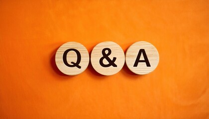 Business Concept Featuring 'Q and A' Text on Wooden Circles with Vibrant Orange Background