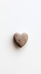 Top view of a heart made of stone on a white background, vertical location. Valentine's Day postcard template.