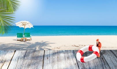 Miniature worker with lifebuoy on wooden floor over tropical beach background, summer outdoor day light, travel industry