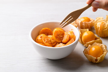 Cape gooseberry or Golden berry (Physalis peruviana) with chili powder and sugar, Spicy fruit salad