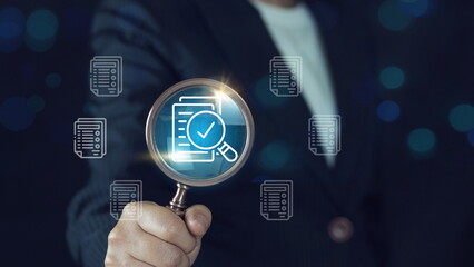 Hand holding magnifying glass over a document icon with checklist, Document review and approval.Document review process and quality control concept.