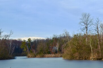 lake landscape, autumn frozen pond, blue sky background
