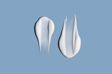 Cosmetic smear of cream texture on a blue background. Skin care.