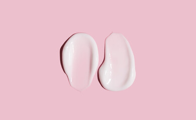 Cosmetic smear of cream texture on a pink background. Skin care.