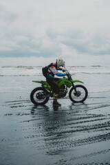 Obraz premium Enduro Adventure on Bali's Black Sand Beach. Off-Road Motorbike Experience.