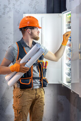 Male construction worker in overalls. Male electrician in overalls.