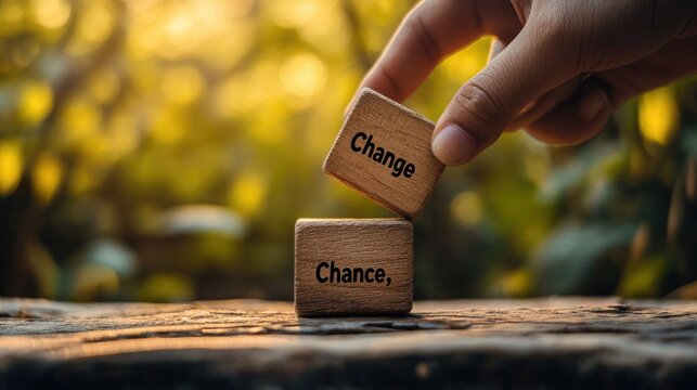 A hand flipping a wooden cube with "Change" to "Chance," symbolizing personal growth, new opportunities, and embracing change in life or career