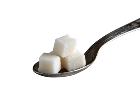 Three white sugar cubes sit on a vintage silver spoon against a black backdrop.