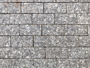 Paving slabs of gray color. Paving stones in walkway