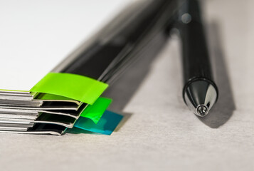 A pile of paper documents and a pen on the table in the office.