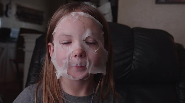 Shot of a Little Girl Removing Facial Mask