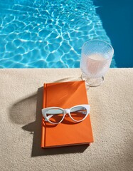 Generated image AI Creative summer scene with orange book, stylish white sunglasses and crystal glass on sunny blue and sandy background. Leisure by the pool idea