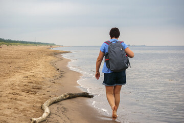 
A woman walks along the sea beach