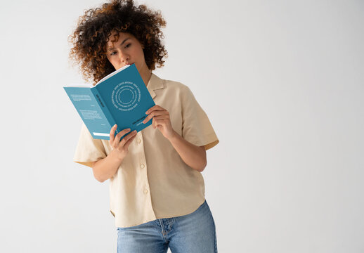 Mockup Of Woman Reading Customizable Book, Concentrating