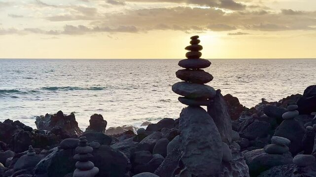 Reunion Island, Etang Sal&eacute;, energetic Vortex cairns beach with stones in balance during sunset