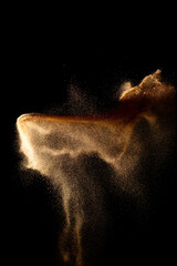 Sand flying explosion isolated on black background ,throwing freeze stop motion object design.