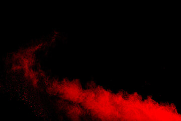 A red cloud of powder on black background.