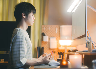 Man sitting meditation posture at home chakra connection to higher self and spiritual