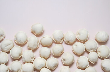 Frozen dumplings on neutral background with copy space.