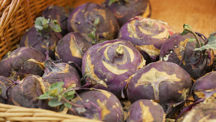 Close-up of many kohlrabi cabbages in a wicker basket