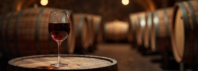 Spanish red wine glass on wooden barrel in cozy cellar, indulgence