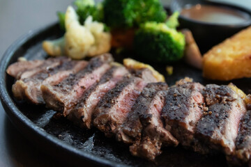 Delicious steak with hash brown, vegetables and sauce.