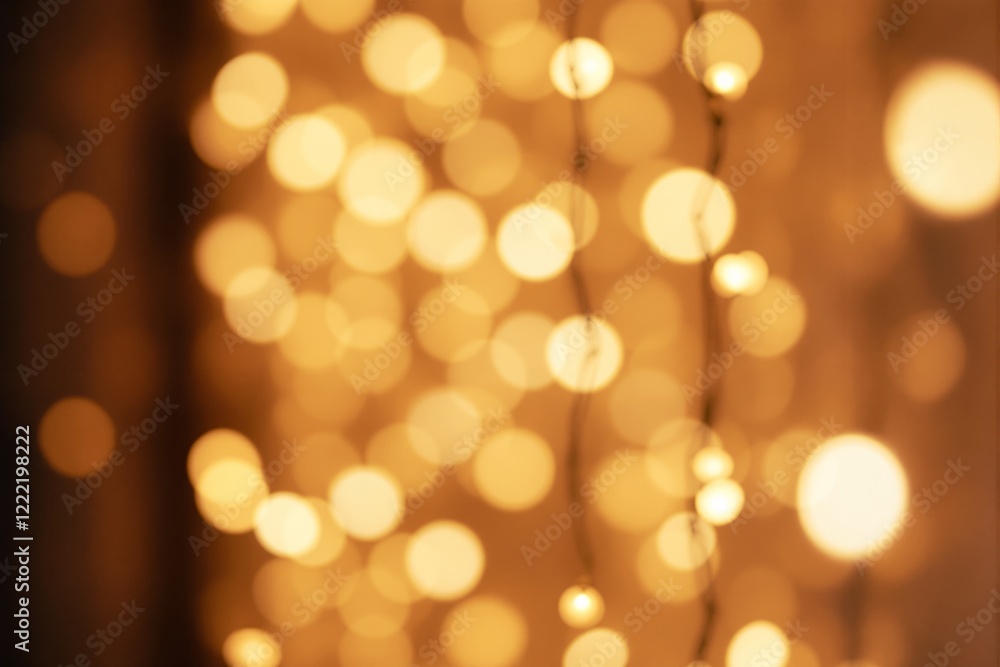 Poster Abstract blurred warm golden bokeh lights with glowing orbs on a soft brown background.