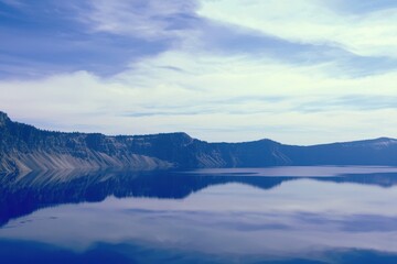 Naklejka premium Mountain Lake Gradient: A mountain lake with water transitioning from clear near the shore to deep blue in the center.