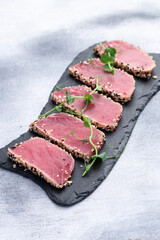 Sliced tuna steak with sesame photography . Top view
