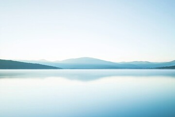 Fototapeta premium Mountain Lake Gradient: A mountain lake with water transitioning from clear near the shore to deep blue in the center.