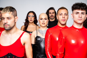 Bald Transgender Woman Stands Confidently With Diverse Queer Crew in Vibrant Attire