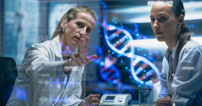 Physician And Patient Examine A Holographic Dna Model. AI-Powered Genomic Analysis Highlights Mutation Hotspots And Therapeutic Targets In Real-Time, Precision Medicine And Targeted Gene Therapies. - Powered by Adobe