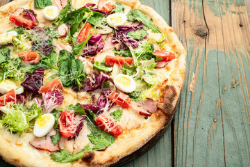 Italian pizza caesar with eggs salad chicken tomatoes and mozzarella photography. top view