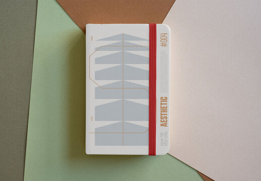 Green Notebook With Elastic Closure on Colorful Background