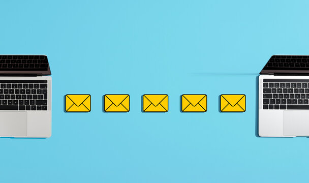 Email transferring between two laptops on blue background