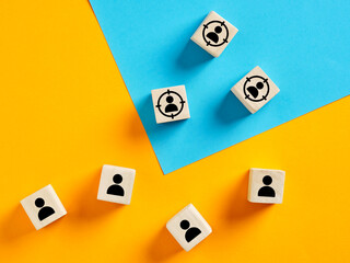 Targeting potential customers, customer retention and identification with wooden cubes on colorful...