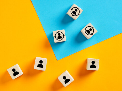 Targeting potential customers, customer retention and identification with wooden cubes on colorful background