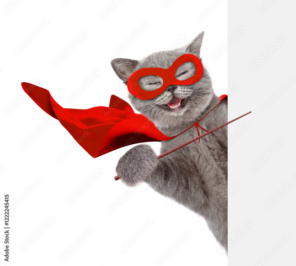 Poster happy cat wearing superhero costume looking above from behind blank white banner and pointing on emp