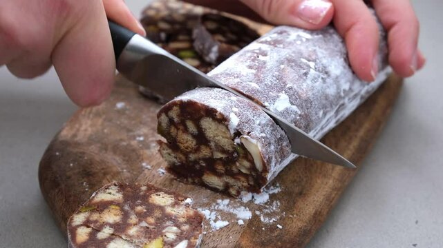 Chocolate salami with nuts on white background. Traditional Italian sweet sausage for Easter.