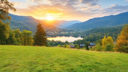 Obraz premium Breathtaking Sunrise Over Mountains and Lake Surrounded by Lush Greenery and Vibrant Sky