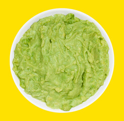 Bowl of fresh guacamole isolated on a vibrant yellow background, perfect for food concepts, Mexican cuisine, or healthy eating themes.