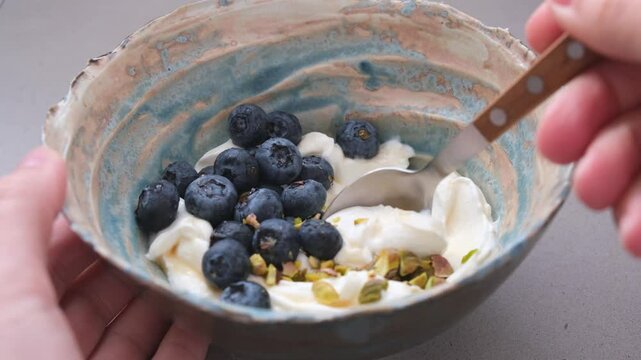 Greek yogurt with blueberries and pistachio bowl. Healthy breakfast concept.
