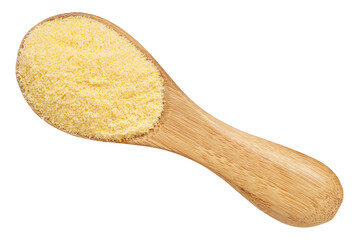 Wooden spoon filled with fine yellow cornmeal, isolated on a white background, ideal for baking, cooking, or gluten-free recipes.