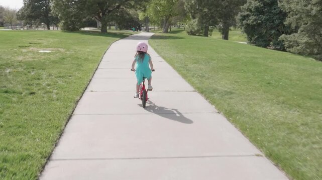Little Gril Riding Bike at a Park