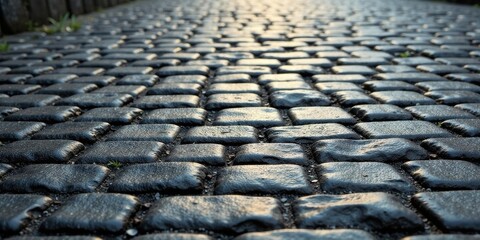 A Dark Cobblestone Path Beckons, Sunlight Illuminating the Way Forward, a Textured Surface with Subtle Depth and Perspective