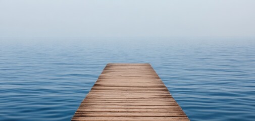 Wooden Pier Extending into Calm Blue Waters Under Clear Sky Creating Tranquil Atmosphere