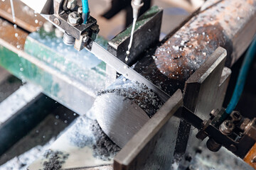 Band saw cutting machine cut metal blank with liquid coolant method, Industrial tool.